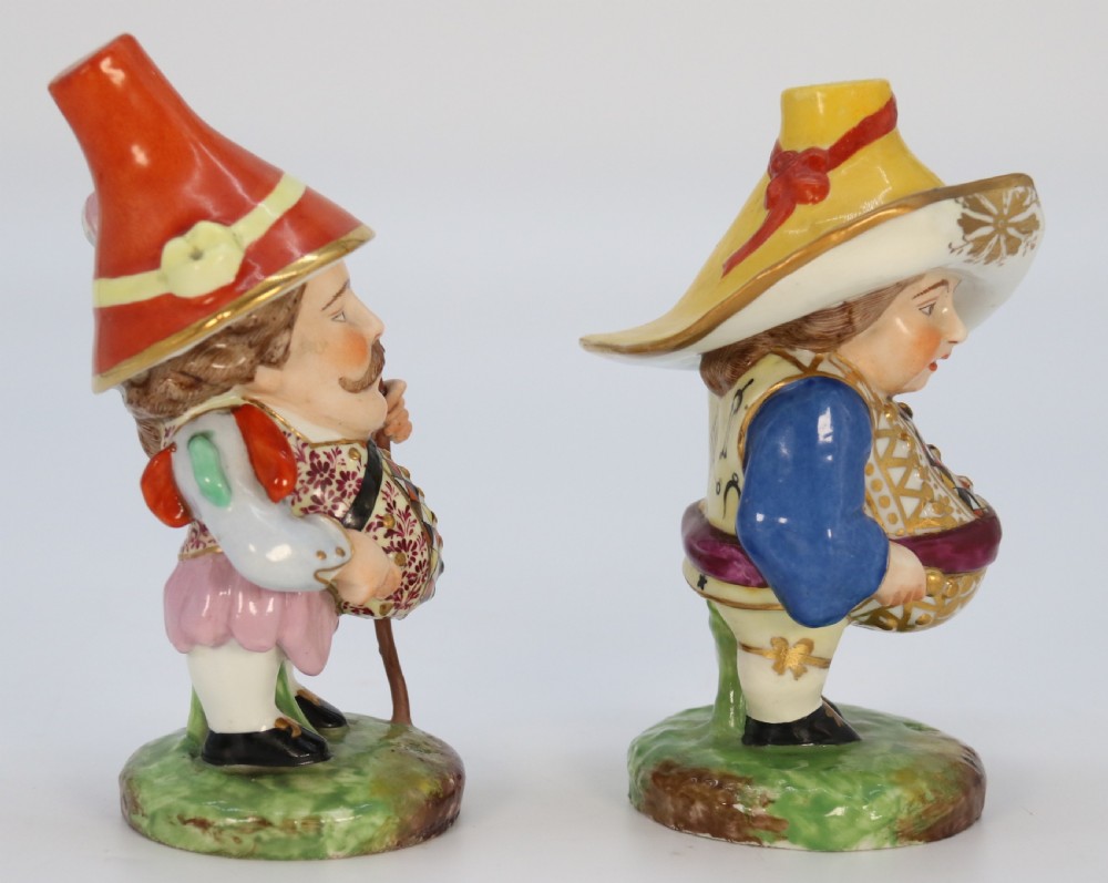 A pair of 19th-century hand-painted Samson porcelain Mansion House dwarf figurines featuring oversized hats and patterned waistcoats. View VII