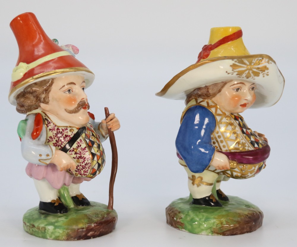A pair of 19th-century hand-painted Samson porcelain Mansion House dwarf figurines featuring oversized hats and patterned waistcoats. View VIII