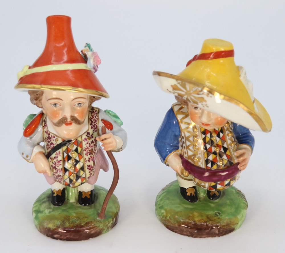 A pair of 19th-century hand-painted Samson porcelain Mansion House dwarf figurines featuring oversized hats and patterned waistcoats. View XI