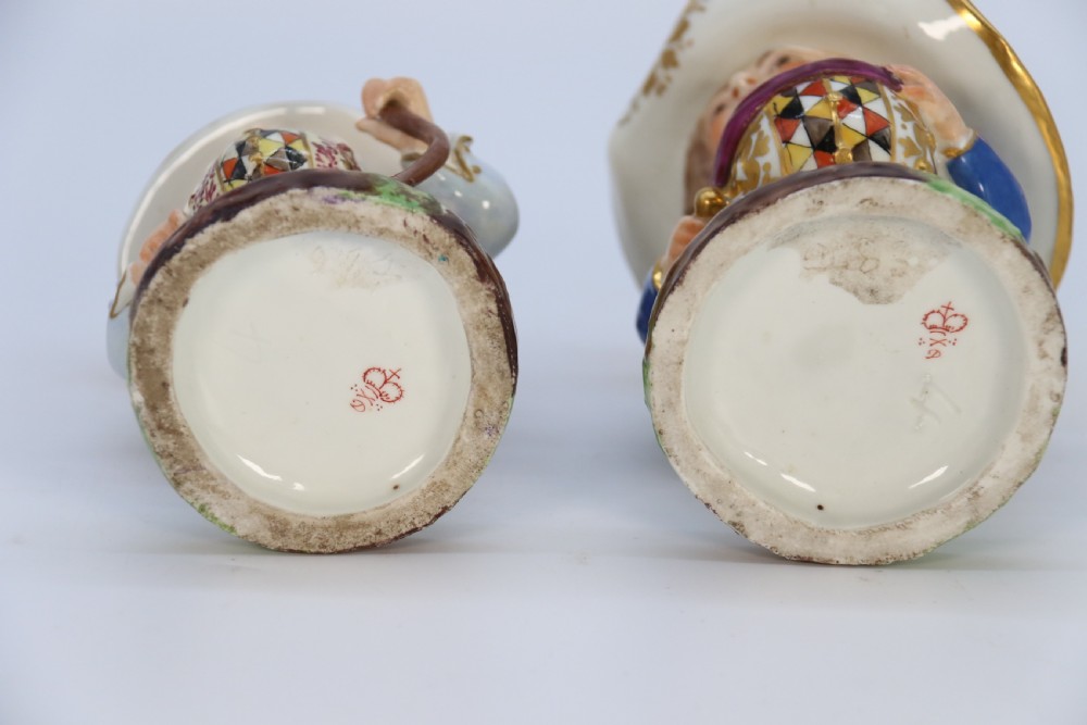 A pair of 19th-century hand-painted Samson porcelain Mansion House dwarf figurines featuring oversized hats and patterned waistcoats. View XII