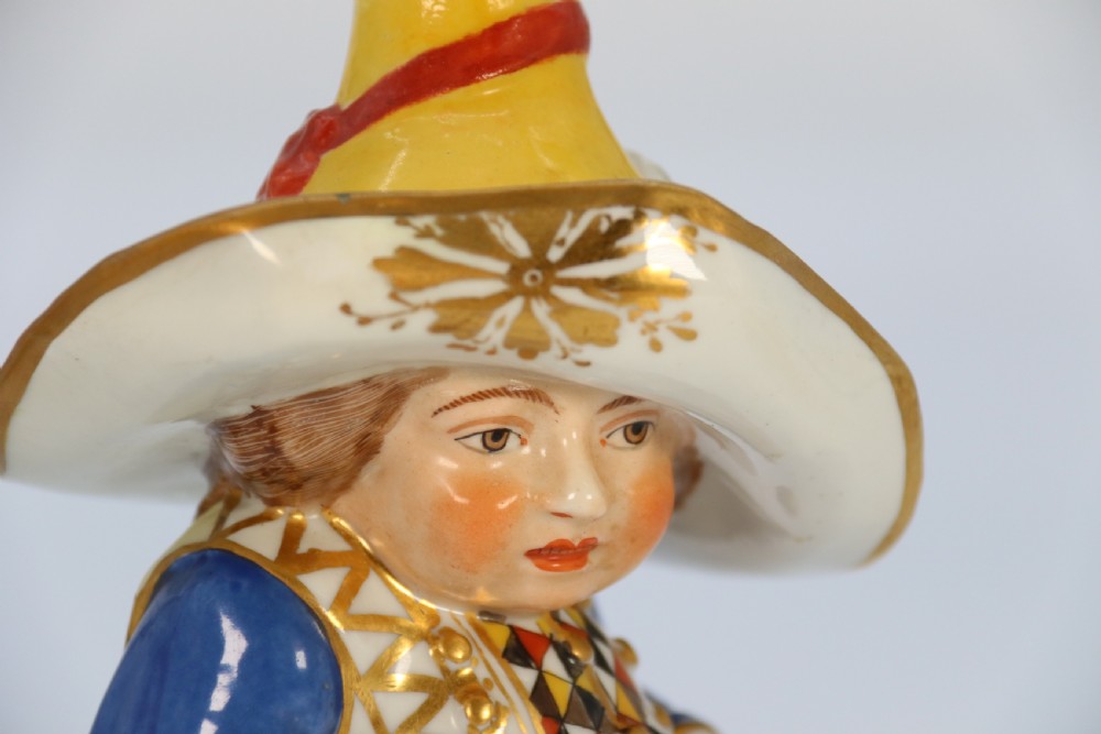 A pair of 19th-century hand-painted Samson porcelain Mansion House dwarf figurines featuring oversized hats and patterned waistcoats. View XXVIII
