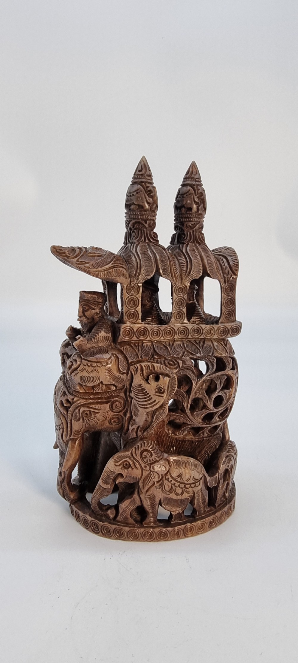 An intricately hand-carved brown soapstone sculpture featuring a ceremonial elephant carrying an elaborate howdah with pierced lattice detailing. View III