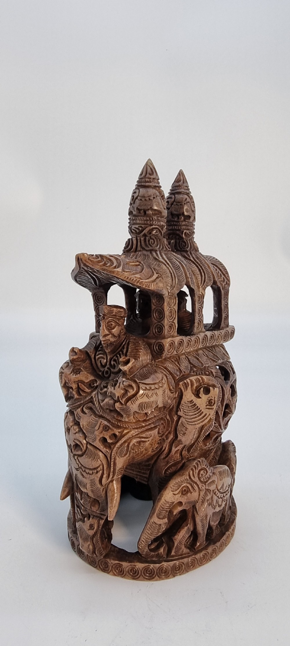 An intricately hand-carved brown soapstone sculpture featuring a ceremonial elephant carrying an elaborate howdah with pierced lattice detailing. View IV
