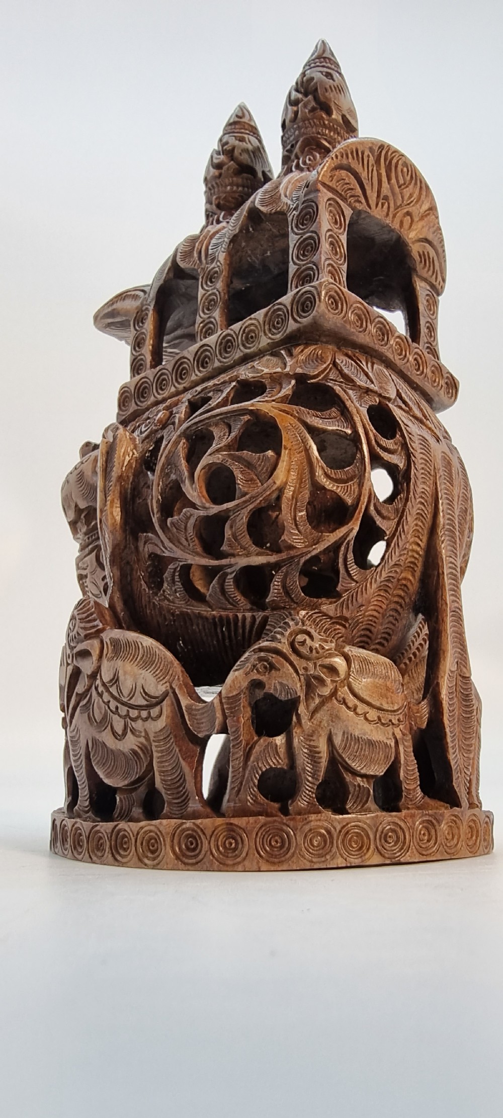 An intricately hand-carved brown soapstone sculpture featuring a ceremonial elephant carrying an elaborate howdah with pierced lattice detailing. View IX