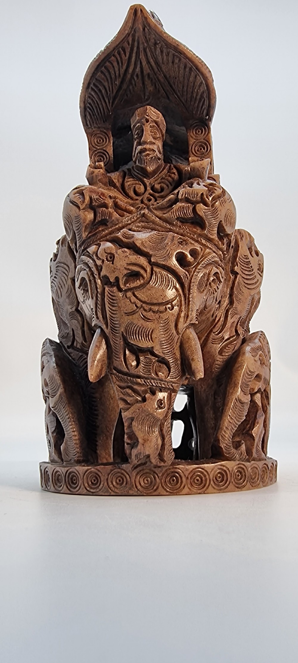 An intricately hand-carved brown soapstone sculpture featuring a ceremonial elephant carrying an elaborate howdah with pierced lattice detailing. View XIII