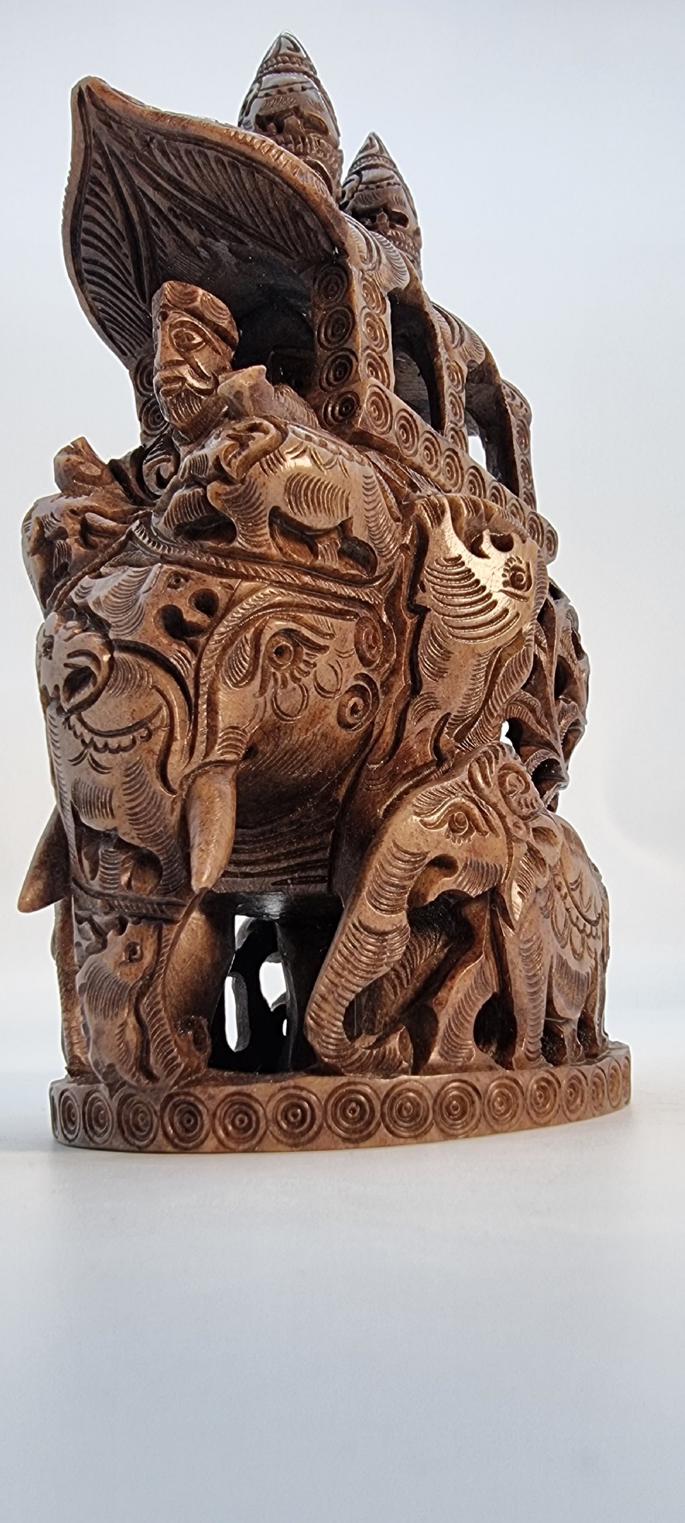 An intricately hand-carved brown soapstone sculpture featuring a ceremonial elephant carrying an elaborate howdah with pierced lattice detailing. View XIV