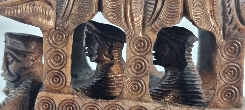 An intricately hand-carved brown soapstone sculpture featuring a ceremonial elephant carrying an elaborate howdah with pierced lattice detailing. View XVI