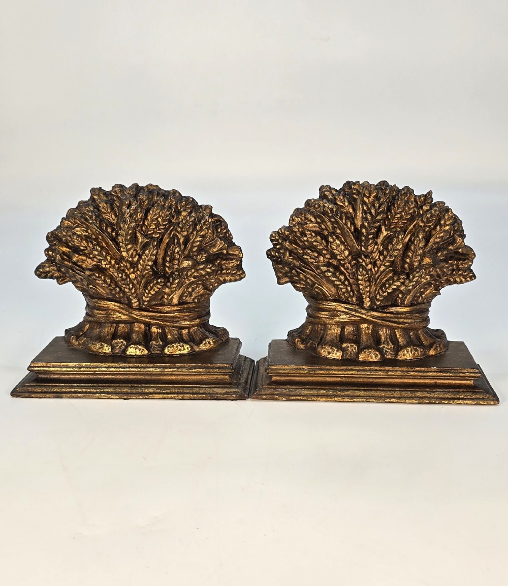 A pair of antique Regency period bookends featuring detailed sculpted wheat sheaves with a gilded finish mounted on stepped bases. View III