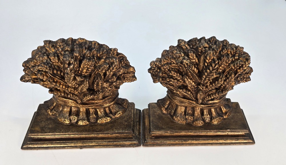 A pair of antique Regency period bookends featuring detailed sculpted wheat sheaves with a gilded finish mounted on stepped bases. View IV