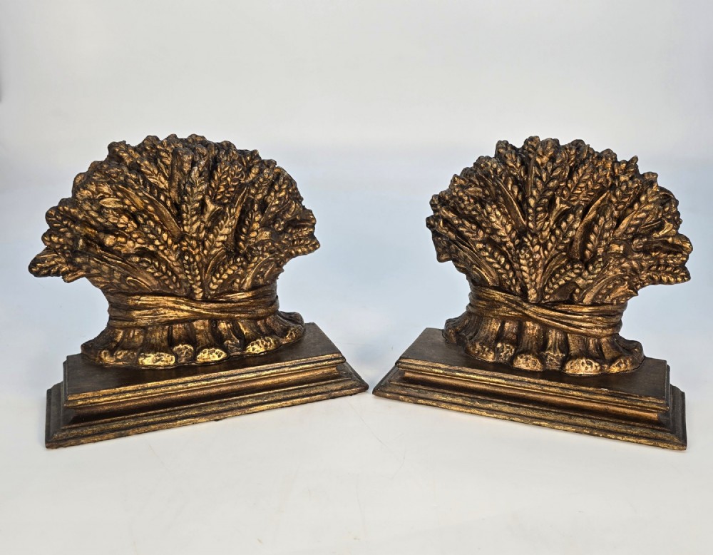 A pair of antique Regency period bookends featuring detailed sculpted wheat sheaves with a gilded finish mounted on stepped bases. View V