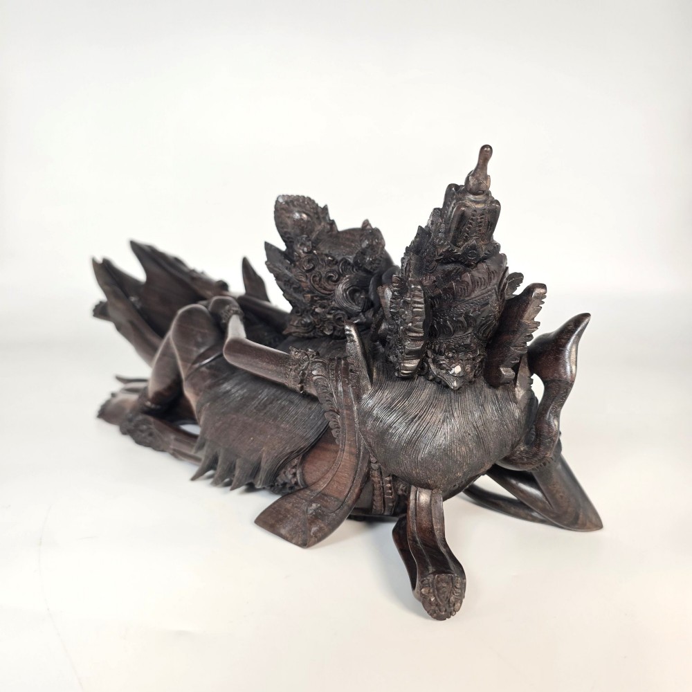 A dark hardwood Balinese carving depicting the reclining figures of Rama and Sita with detailed ornate headdresses and traditional attire. View IV