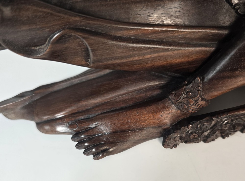 A dark hardwood Balinese carving depicting the reclining figures of Rama and Sita with detailed ornate headdresses and traditional attire. View XI