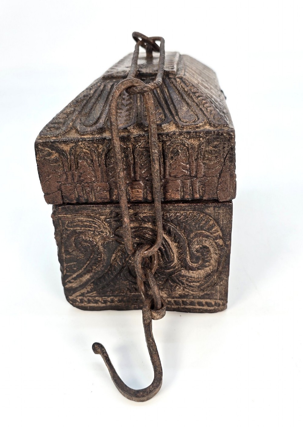 An 18th-century Indian carved dark teak wood spice box featuring a domed lid and attached hand-forged iron hanging chain. View II