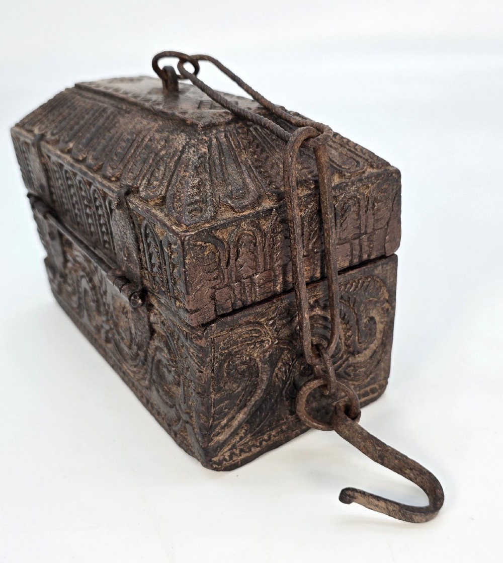 An 18th-century Indian carved dark teak wood spice box featuring a domed lid and attached hand-forged iron hanging chain. View III