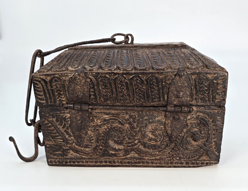 An 18th-century Indian carved dark teak wood spice box featuring a domed lid and attached hand-forged iron hanging chain. View IV