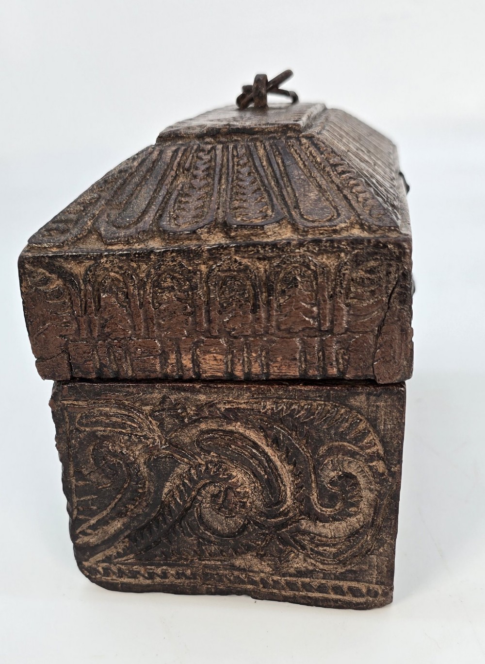 An 18th-century Indian carved dark teak wood spice box featuring a domed lid and attached hand-forged iron hanging chain. View VI