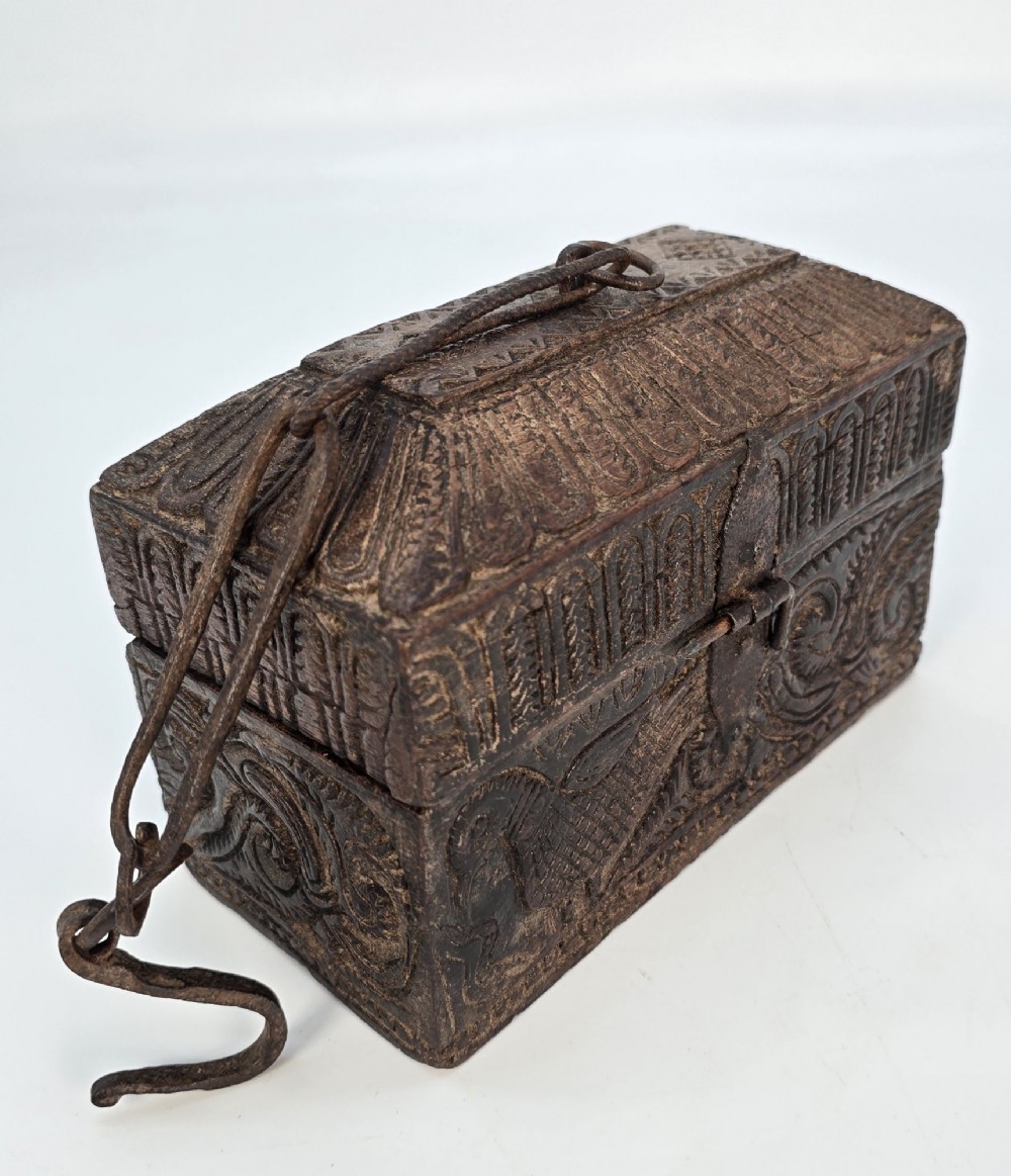 An 18th-century Indian carved dark teak wood spice box featuring a domed lid and attached hand-forged iron hanging chain. View VII