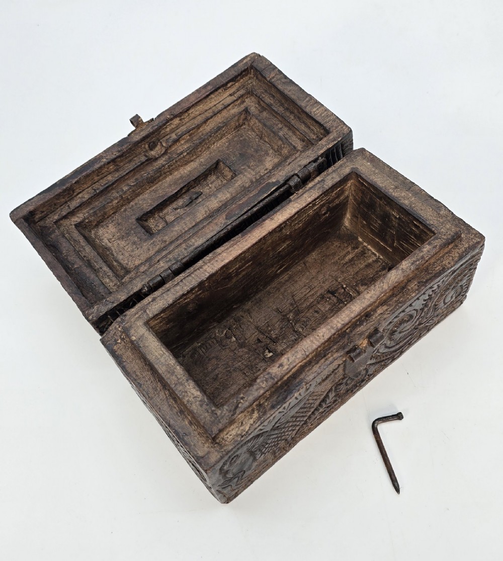 An 18th-century Indian carved dark teak wood spice box featuring a domed lid and attached hand-forged iron hanging chain. View VIII