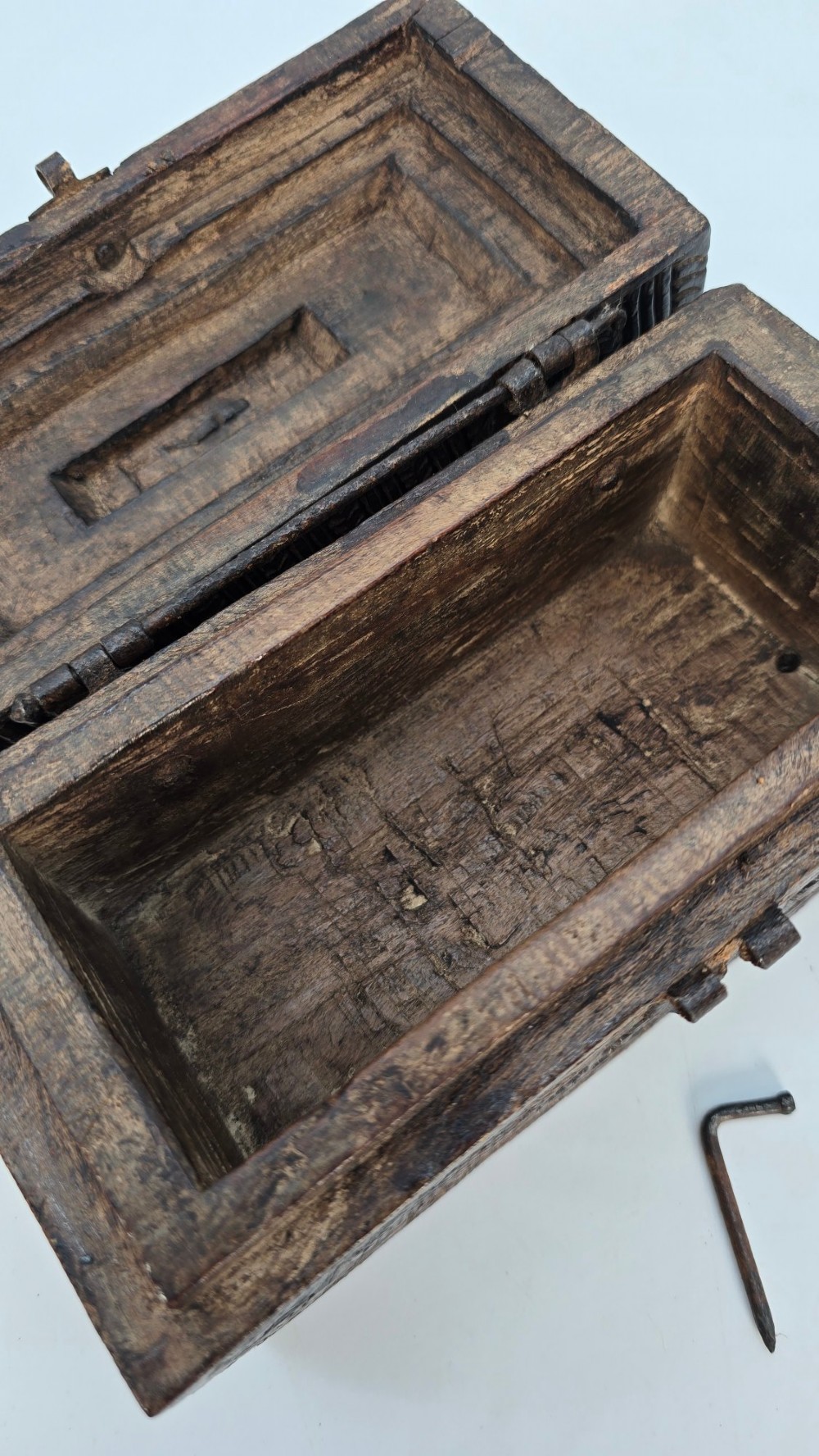 An 18th-century Indian carved dark teak wood spice box featuring a domed lid and attached hand-forged iron hanging chain. View IX