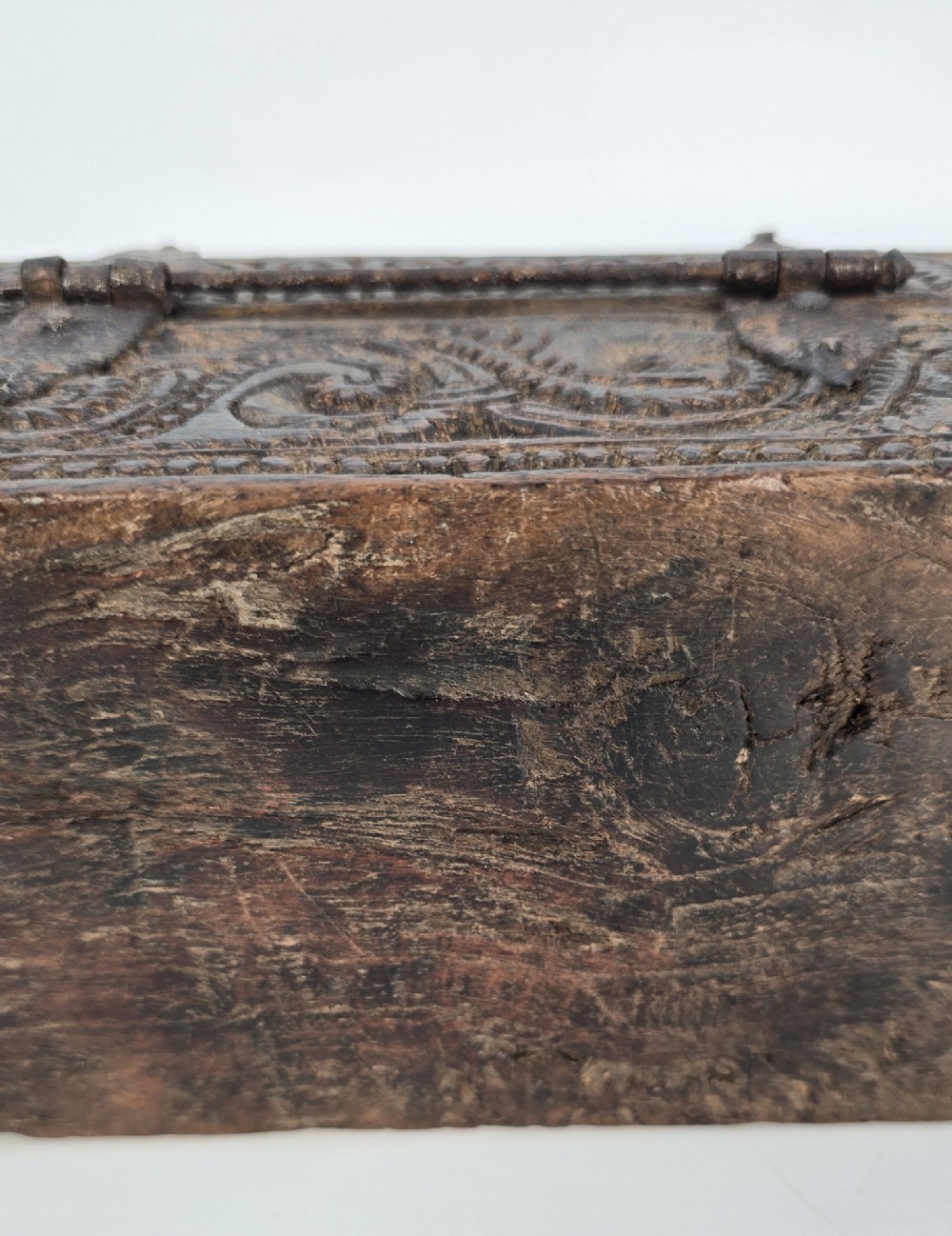 An 18th-century Indian carved dark teak wood spice box featuring a domed lid and attached hand-forged iron hanging chain. View XI