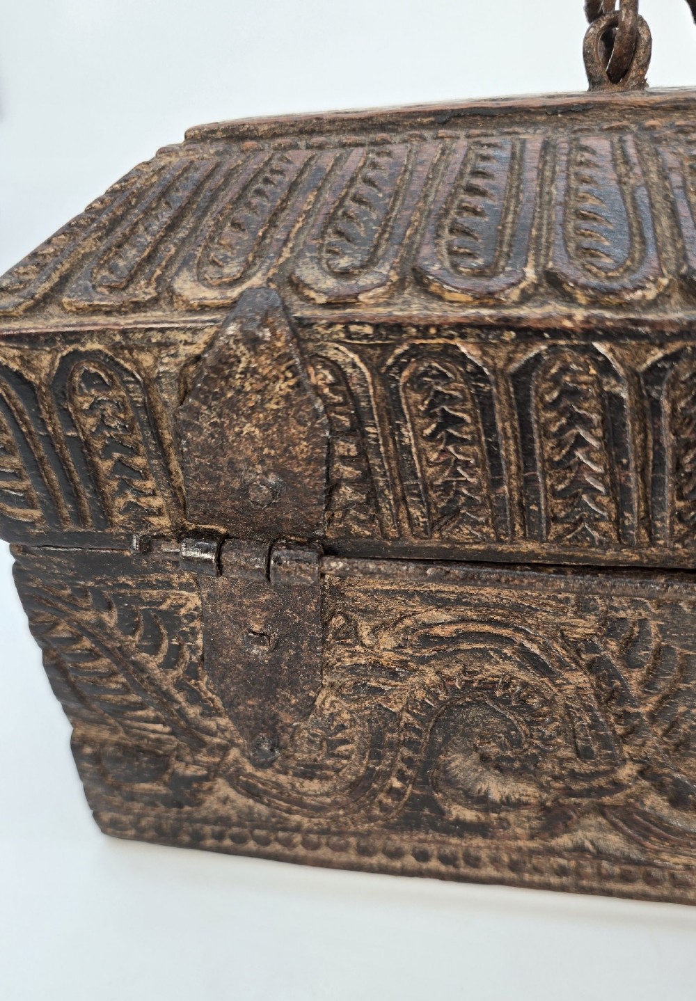 An 18th-century Indian carved dark teak wood spice box featuring a domed lid and attached hand-forged iron hanging chain. View XII