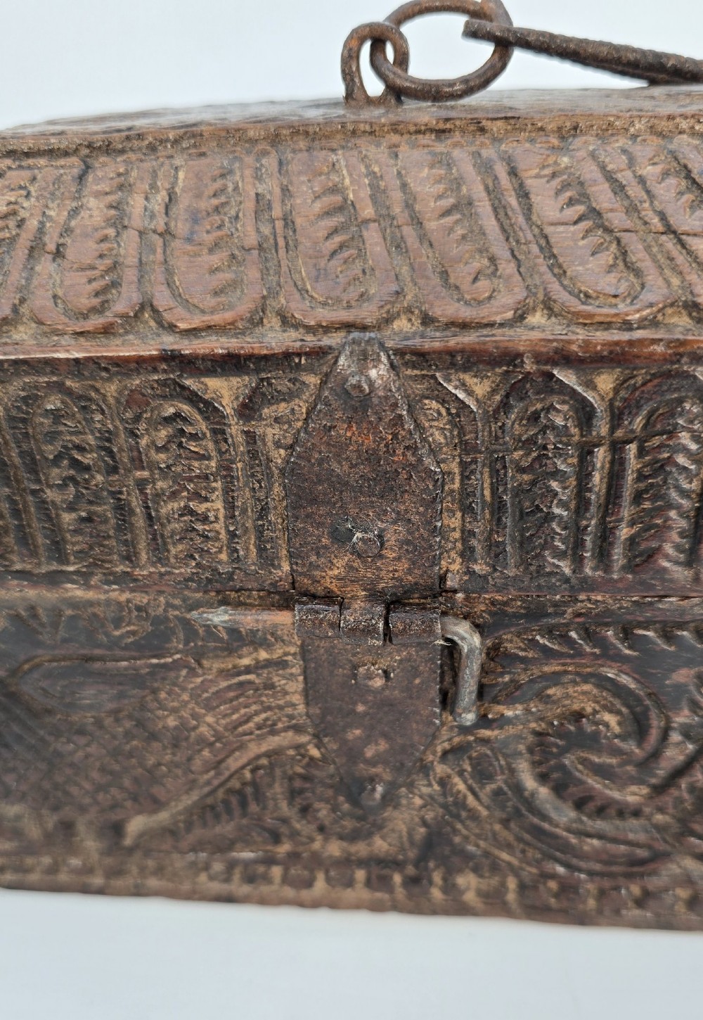 An 18th-century Indian carved dark teak wood spice box featuring a domed lid and attached hand-forged iron hanging chain. View XIII