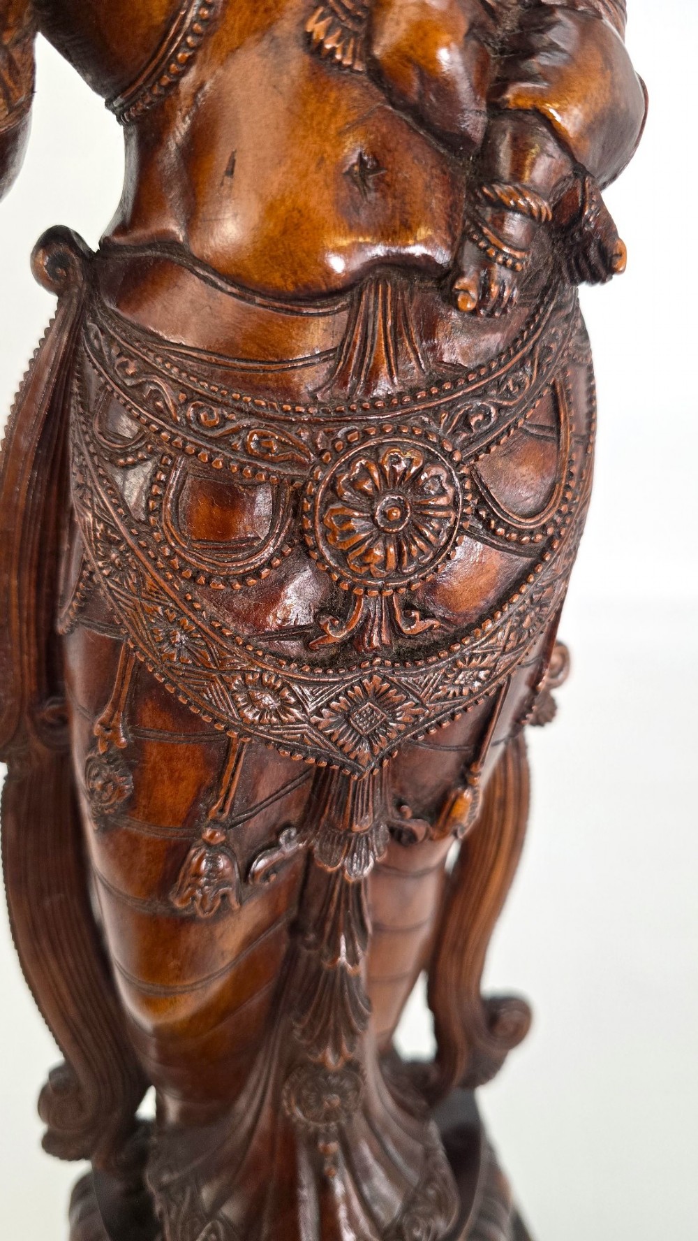 A hand-carved dark wood statue depicting the Goddess Parvati holding infant Ganesha, mounted on an octagonal wooden base. View VI