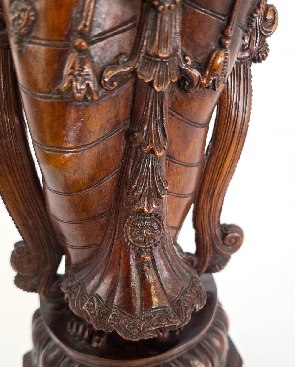 A hand-carved dark wood statue depicting the Goddess Parvati holding infant Ganesha, mounted on an octagonal wooden base. View VII