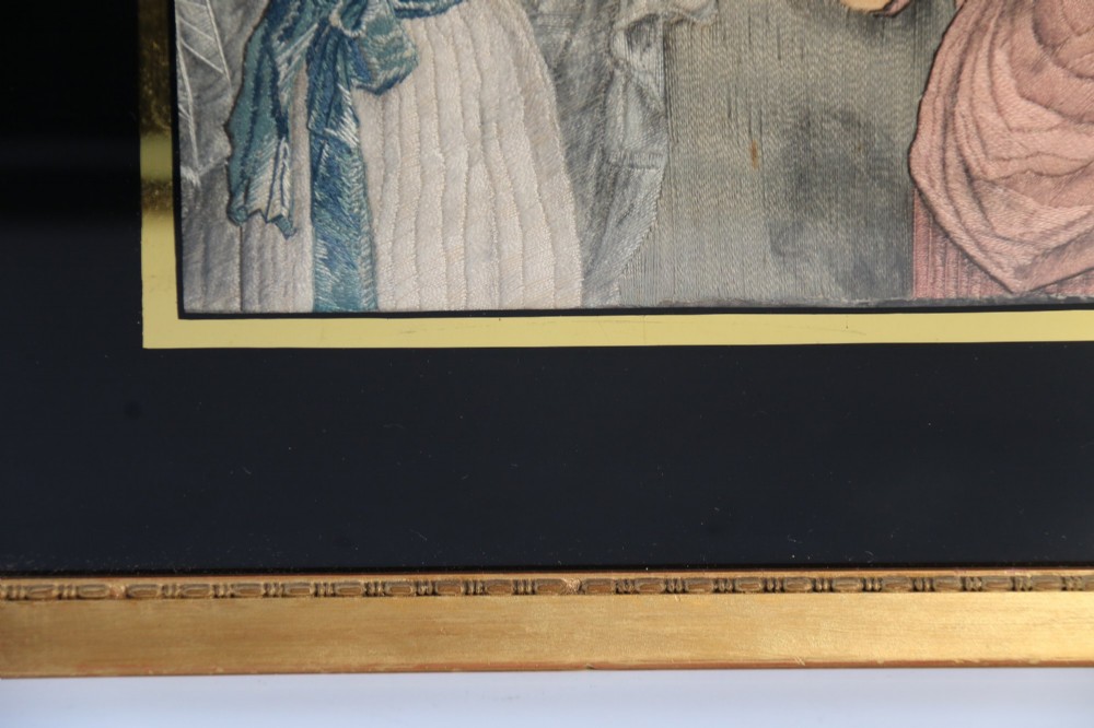 A framed Georgian silk needlework picture depicting two young children with a mask, mounted in a black eglomise frame with gold leaf detailing. View VII