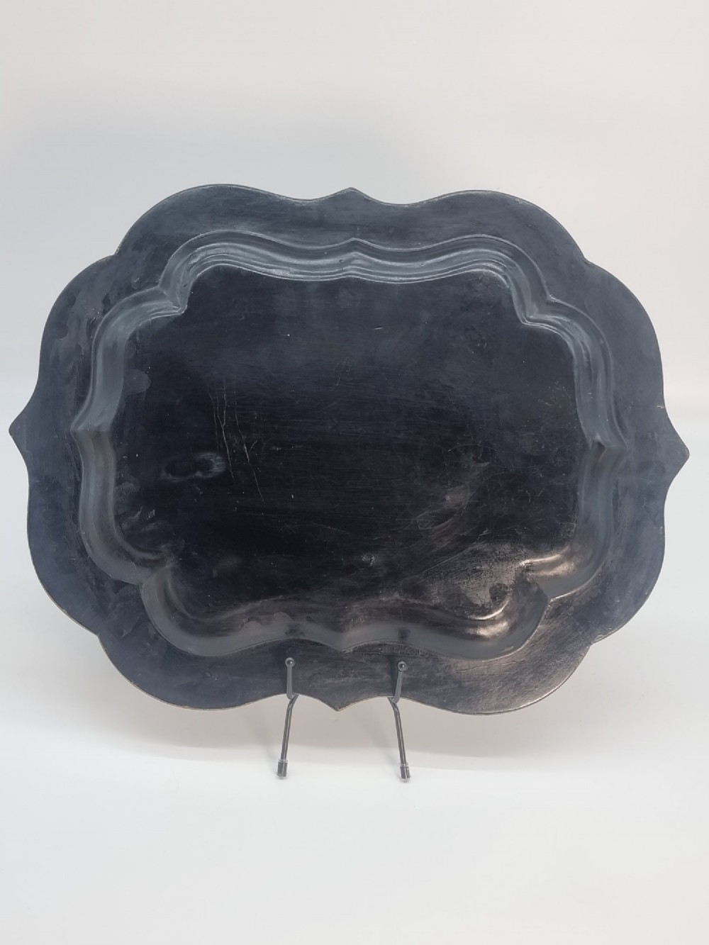 A Victorian shaped papier-mache tray featuring a hand-painted landscape with a castle and peacock surrounded by gold leaf scrollwork on a black background. View XI