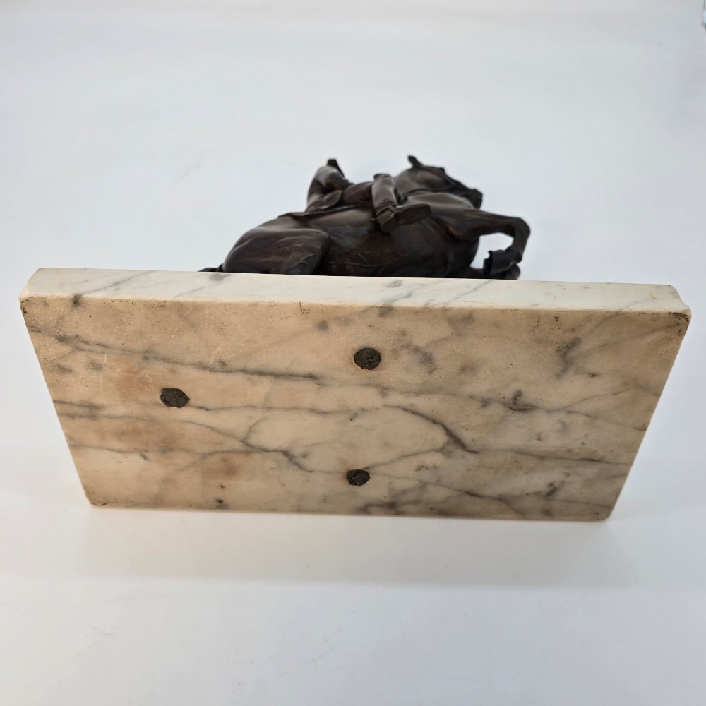 A dark bronze equestrian sculpture depicting a uniformed rider atop a rearing horse, mounted on a rectangular cream marble plinth. View XIV