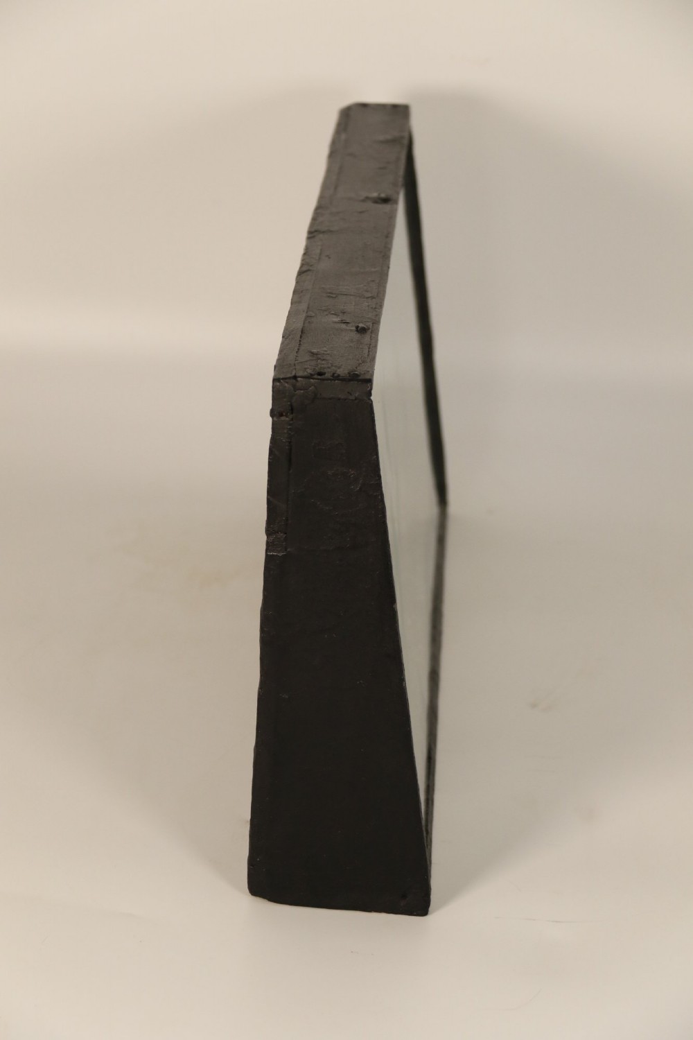 A nineteenth-century glass-fronted black wooden shadow box featuring a carved and painted diorama of two sailing ships and a lighthouse on a textured sea. View IV
