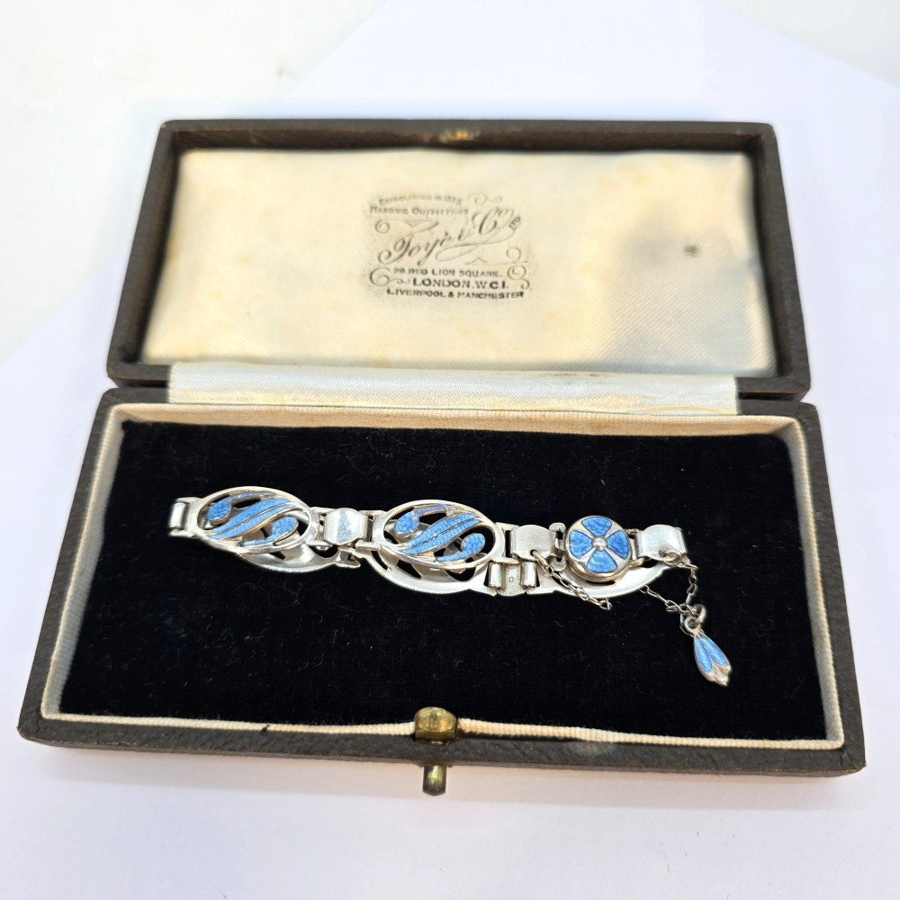 An Edwardian silver link bracelet featuring pierced oval panels filled with light blue enamel and connected by a safety chain. View III