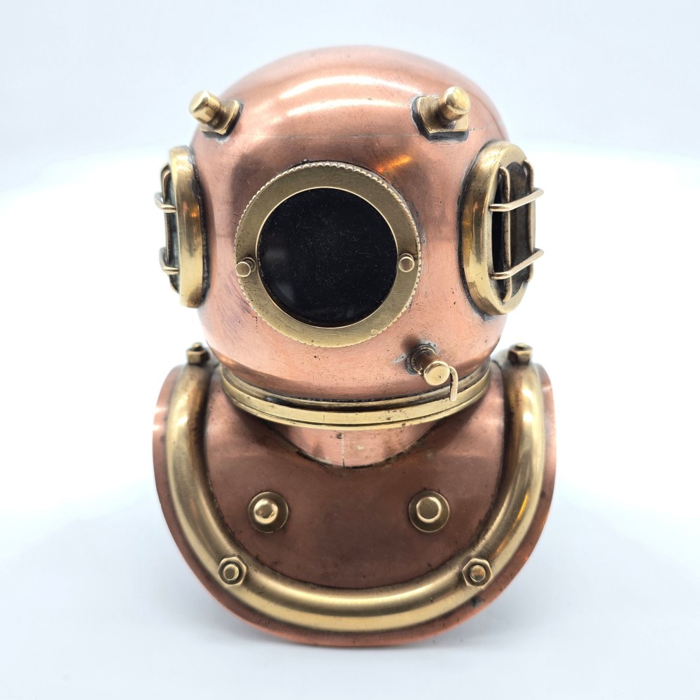 A miniature copper and brass deep-sea divers helmet featuring glass viewports, side valves, and brass shoulder plate studs on a plain white background. View VIII