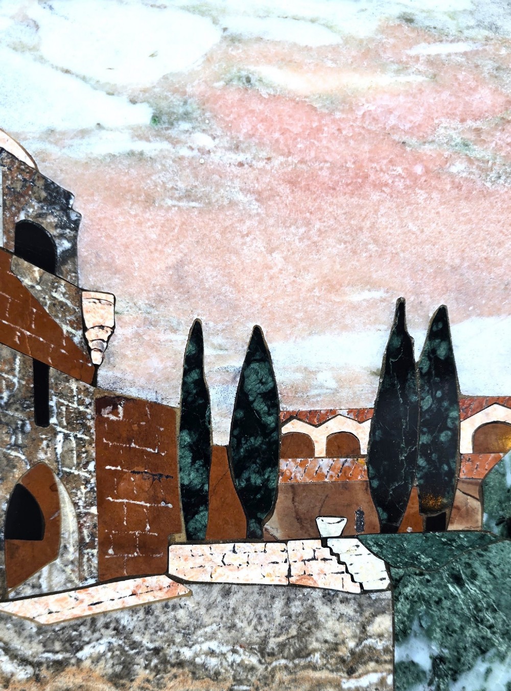 A framed Italian pietra dura panel depicting a stone building and cypress trees rendered in inlaid coloured marble. View IV