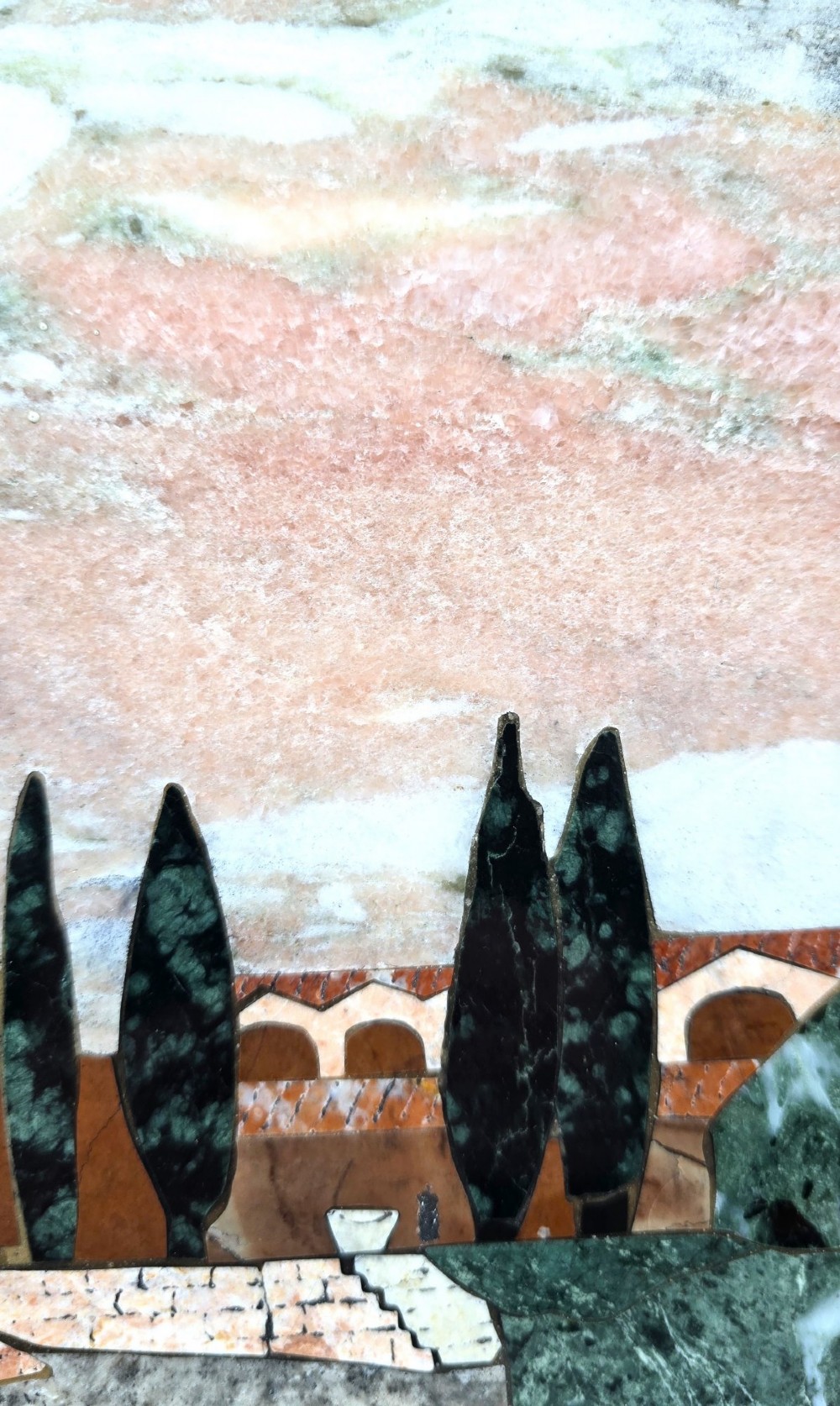 A framed Italian pietra dura panel depicting a stone building and cypress trees rendered in inlaid coloured marble. View V