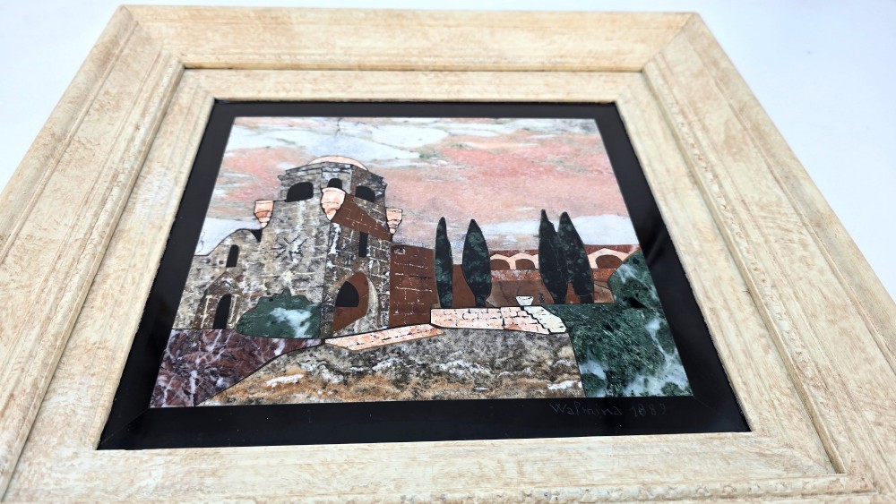 A framed Italian pietra dura panel depicting a stone building and cypress trees rendered in inlaid coloured marble. View XIV