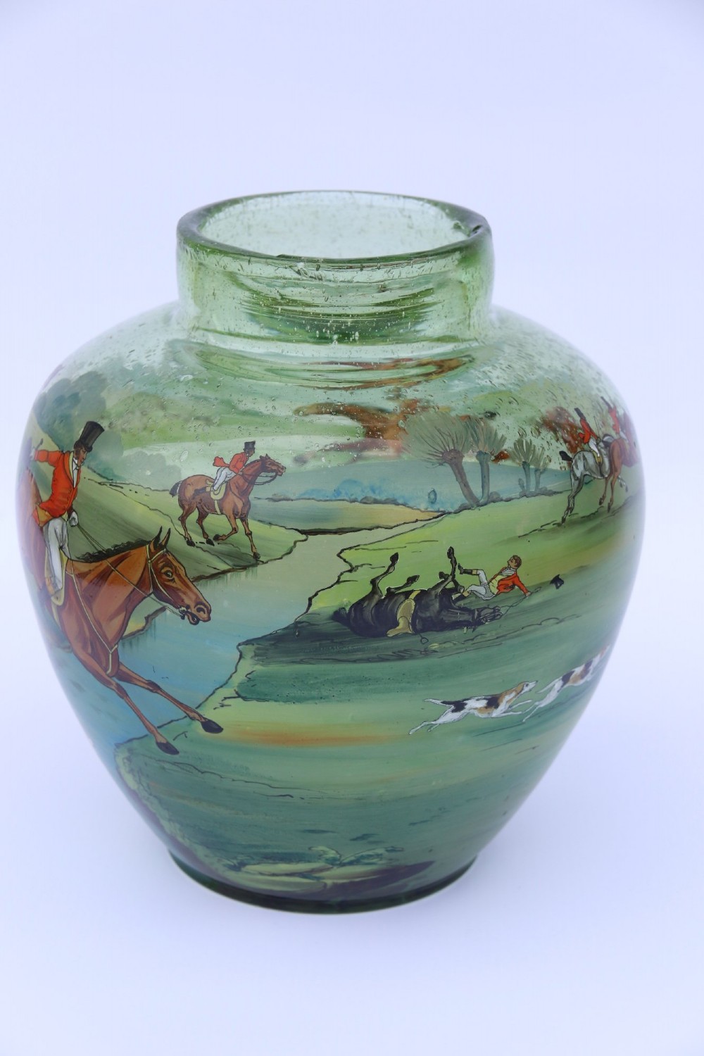 A bulbous green hand-blown glass vase featuring a hand-painted enamel scene of fox hunters riding horses across a landscape. View III