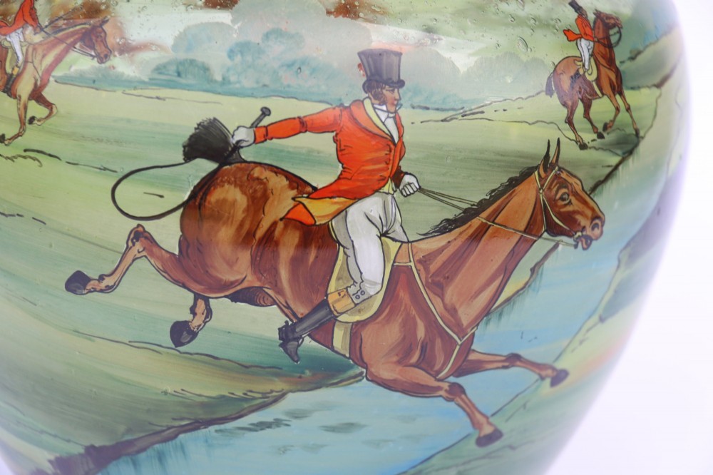 A bulbous green hand-blown glass vase featuring a hand-painted enamel scene of fox hunters riding horses across a landscape. View VI