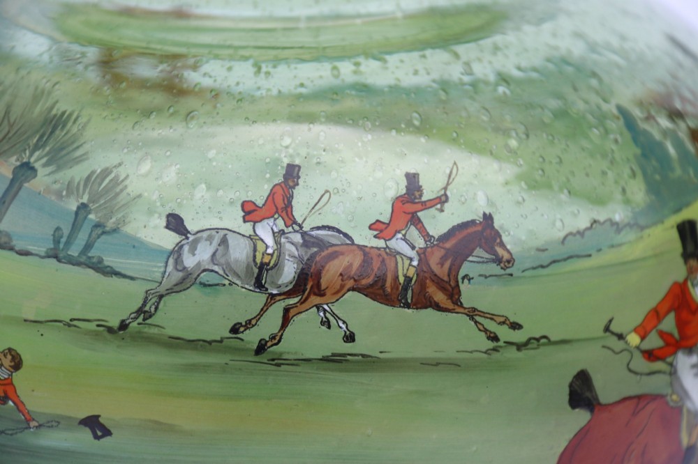 A bulbous green hand-blown glass vase featuring a hand-painted enamel scene of fox hunters riding horses across a landscape. View XI