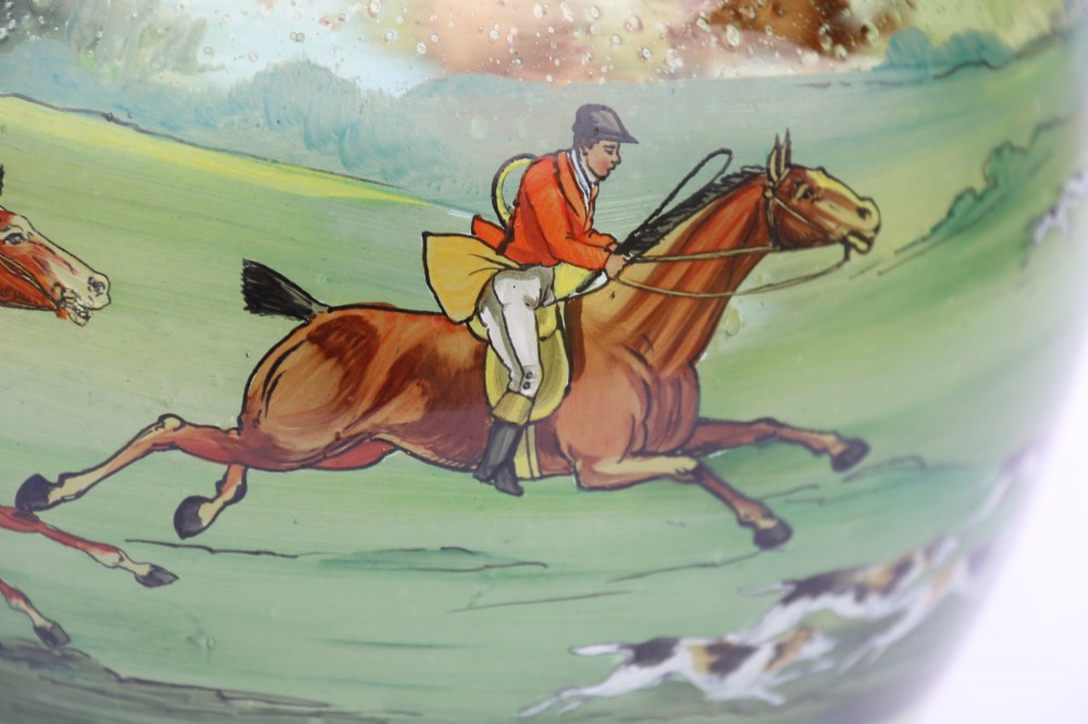 A bulbous green hand-blown glass vase featuring a hand-painted enamel scene of fox hunters riding horses across a landscape. View XIII