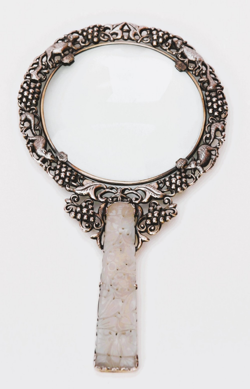 A late 19th-century Chinese silver magnifying glass featuring a carved white jade handle and an openwork grapevine frame with animal details. View III