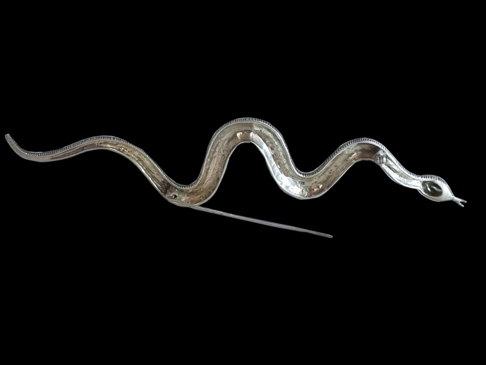 An Art Deco sterling silver brooch formed in the shape of an undulating snake, encrusted with pave-set marcasite stones and detailed with red stone eyes. View III