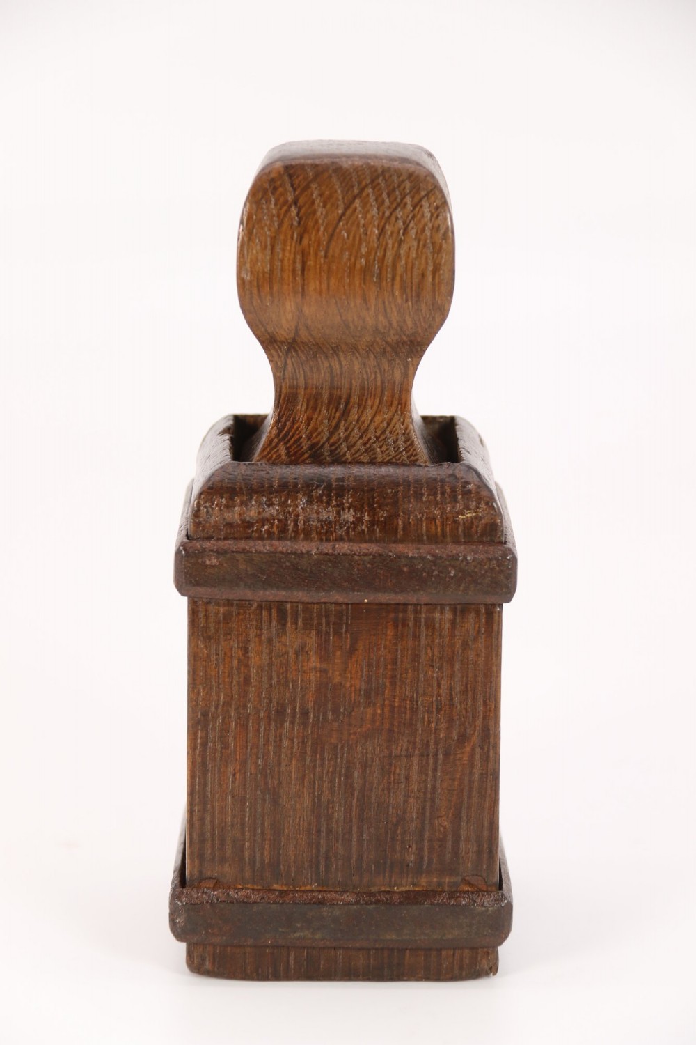 An antique dark oak apothecary crusher set consisting of a square wooden vessel with iron mounts alongside a matching rectangular wooden plunger with a shaped handle. View XII