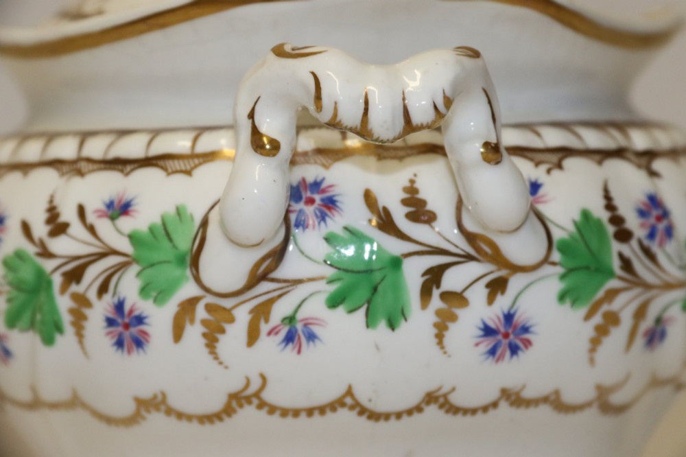A white Regency Spode felspar porcelain covered sucrier featuring hand-painted green leaves, blue cornflowers, twin scrolled handles, and gilded embellishments. View VI
