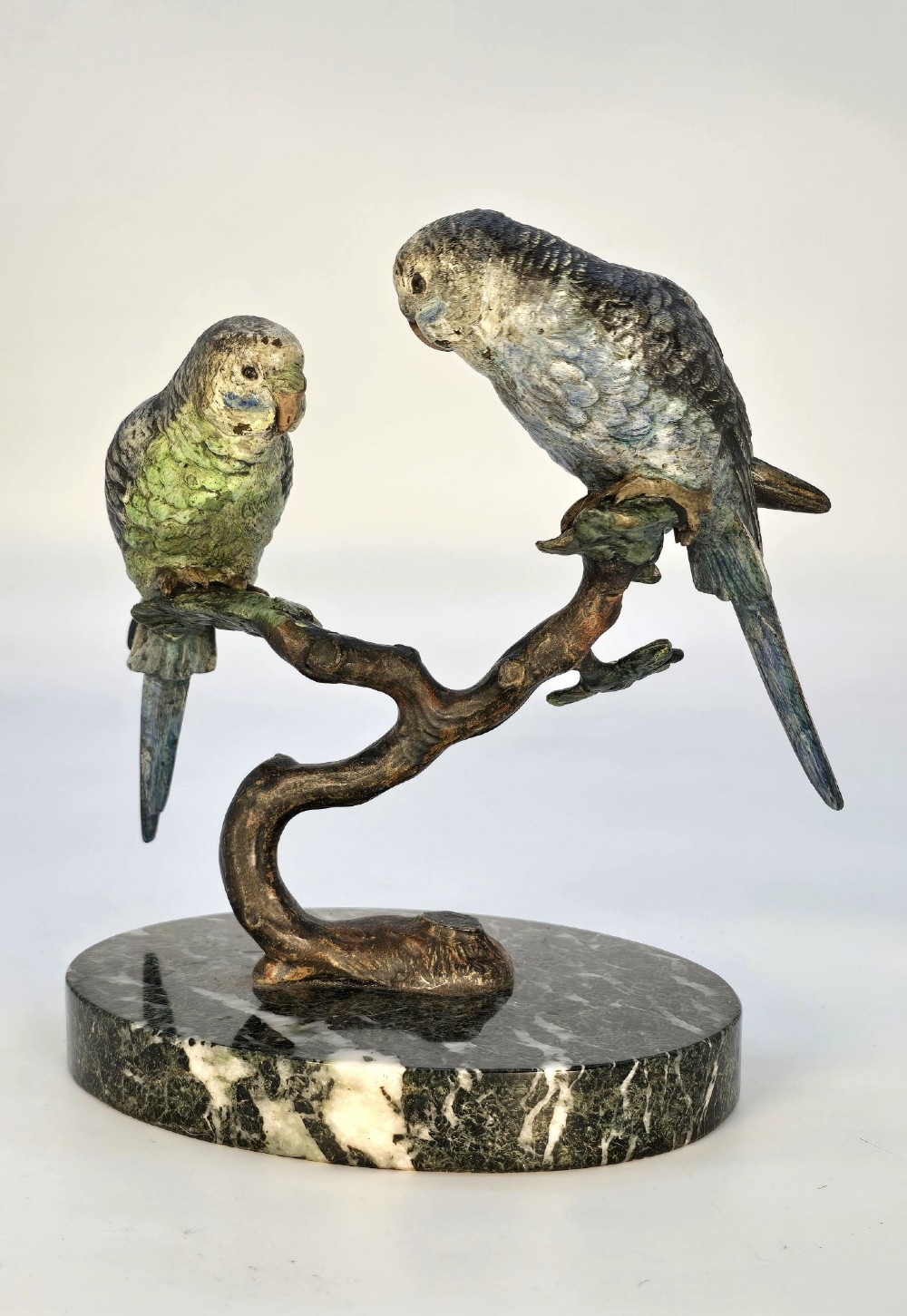 A cold-painted bronze sculpture featuring two budgerigars perched on a branch mounted upon a round green marble base. View II