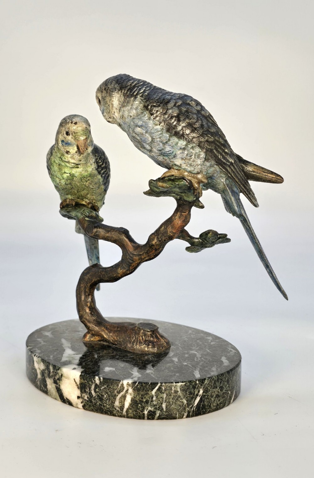 A cold-painted bronze sculpture featuring two budgerigars perched on a branch mounted upon a round green marble base. View III