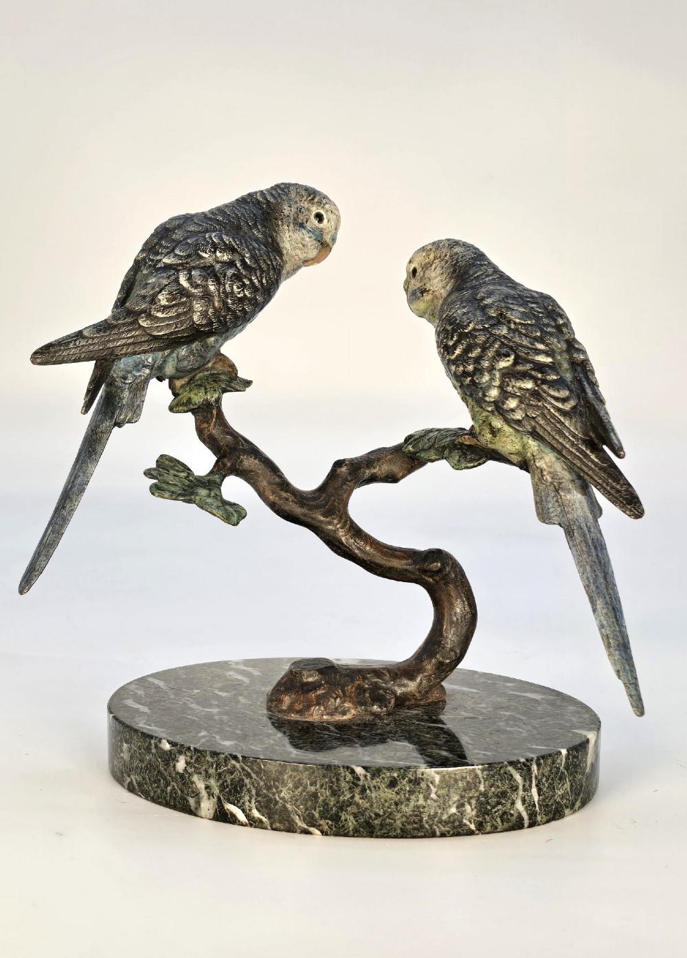 A cold-painted bronze sculpture featuring two budgerigars perched on a branch mounted upon a round green marble base. View VI