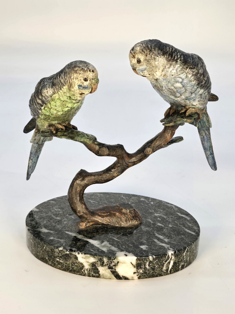 A cold-painted bronze sculpture featuring two budgerigars perched on a branch mounted upon a round green marble base. View XI