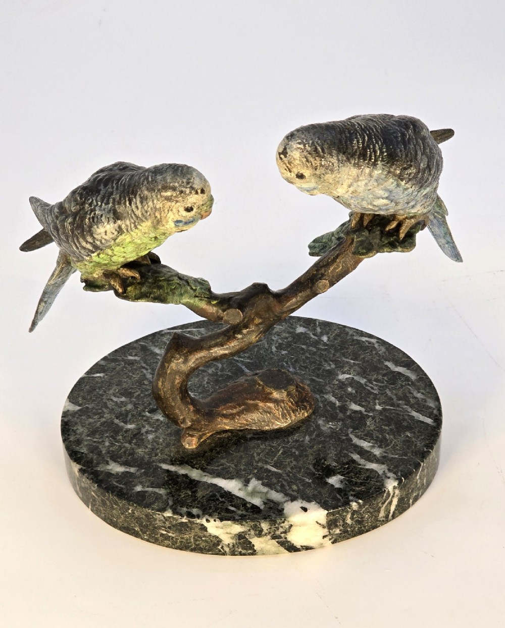 A cold-painted bronze sculpture featuring two budgerigars perched on a branch mounted upon a round green marble base. View XV